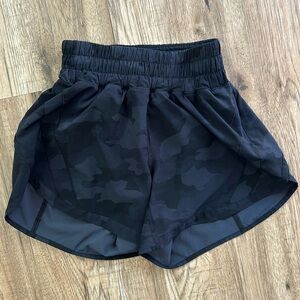 Lululemon track that mid rise shorts in size 0. Black cami.